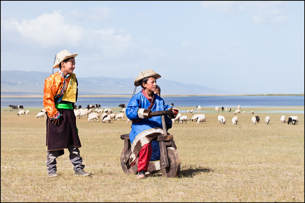 Tibetan kids playing with a wooden bike